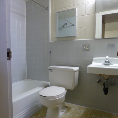 Bathroom featuring a shower, sink, and mirror.