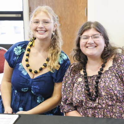 student in hawaiian and professional attire posing