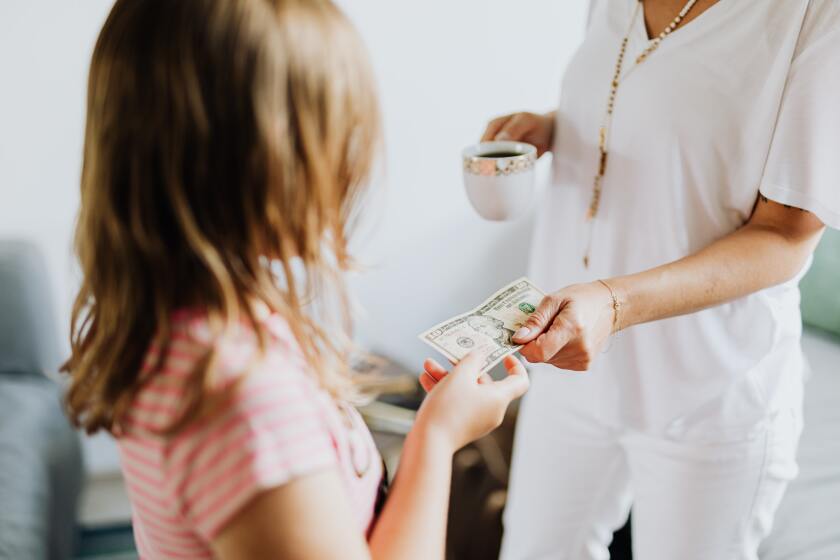 Little girl being handed money