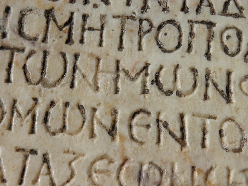 Worn Greek engraving on a piece of stone.