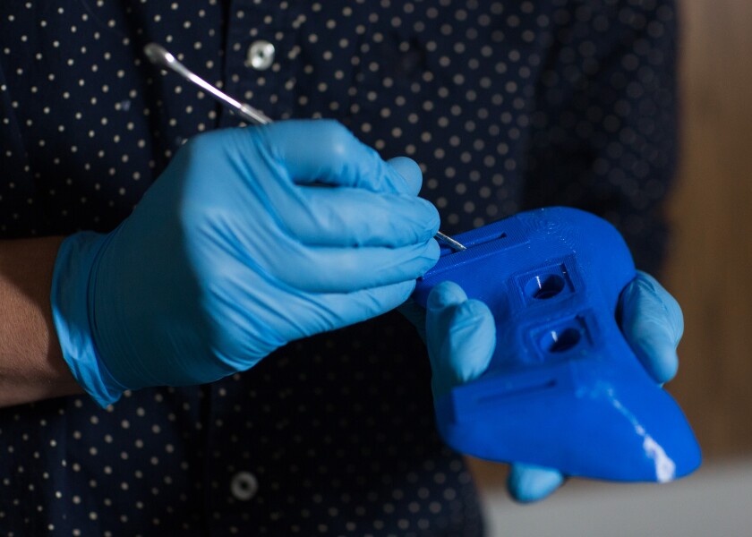 After printing, researchers clean the edges of the prototype