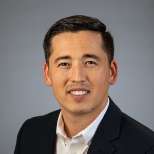 Photo of Max Imangazinov smiling at the camera.