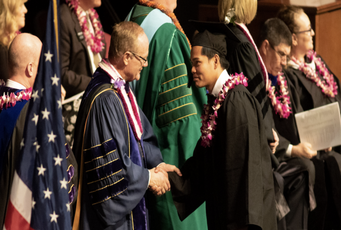 President Tanner congratulates a BYUH graduate