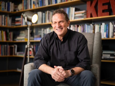 BYU professor Lance Larsen sits in his home library.
