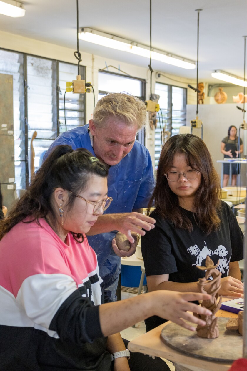 Eric Orr with two of his students discussing their clay therapy projects.