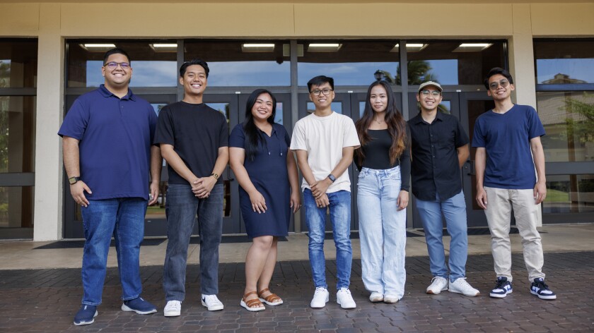 Seven students standing together smiling