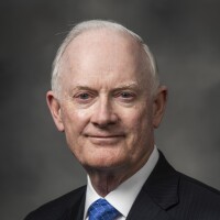 Elder Kim B. Clark smiling for a portrait