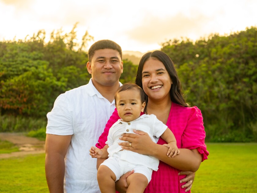 The Uili family smiles for the camera