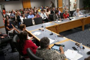 A large audience and members of the Utah State Board of Education listen as members of the Utah House Democratic Caucus Joel Briscoe, Marie Poulsen and Carol Spackman Moss, speak at a public hearing in Salt Lake City , Utah, on Tuesday, July 26, 2016. The Board hosted the hearing to gather public feedback on a new administrative rule that allows schools to hire qualified professionals without teaching experience to fill needs in the classroom. (Spenser Heaps/The Deseret News via AP)