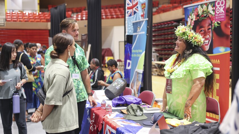 Students speaking to an APCC guest at the Career Fair.