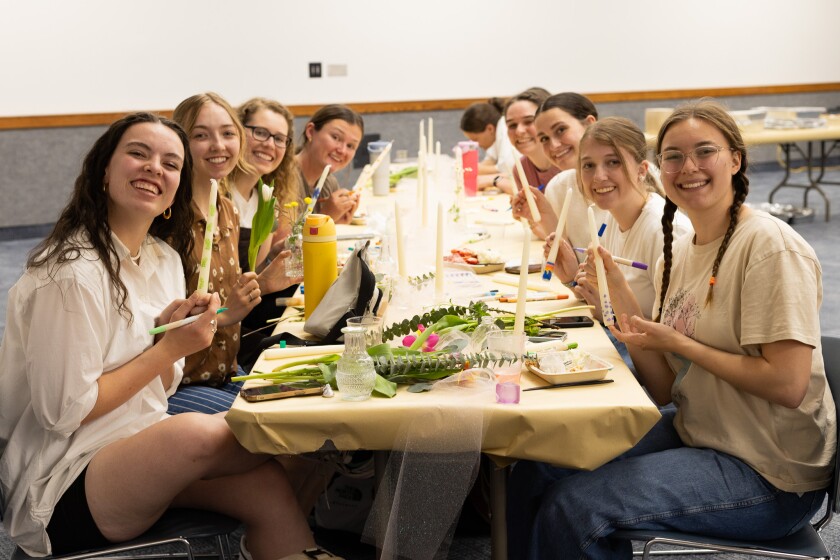 Attendees painting candles at 2025 WEC