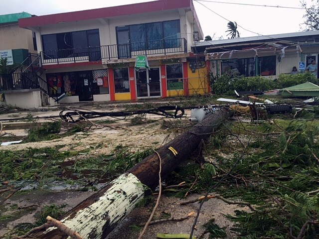 A backyard filled with debris from a typhoon