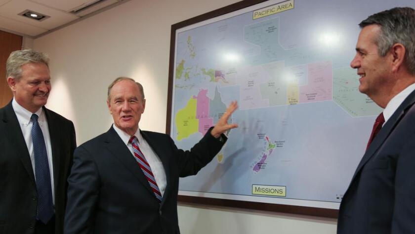 President Tanner pointing to a map of the South Pacific with Elders Arden and Nattress of the Pacific Area Presidency of The Church of Jesus Christ of Latter-day Saints.