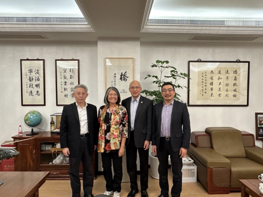 A photo of four people with Peter Chan and Joyce Tan in the middle