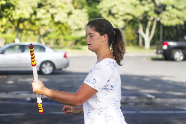 A woman spinning an unlit firekinfe