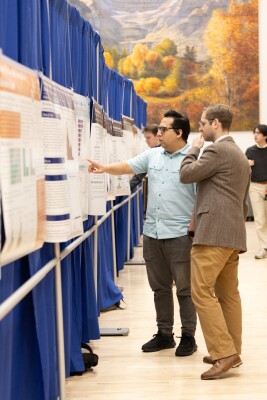 A student presents his research at the college's Mentored Student Research Conference. Each research submission is judged by faculty in the corresponding department. (Photo courtesy of FHSS Media Team)