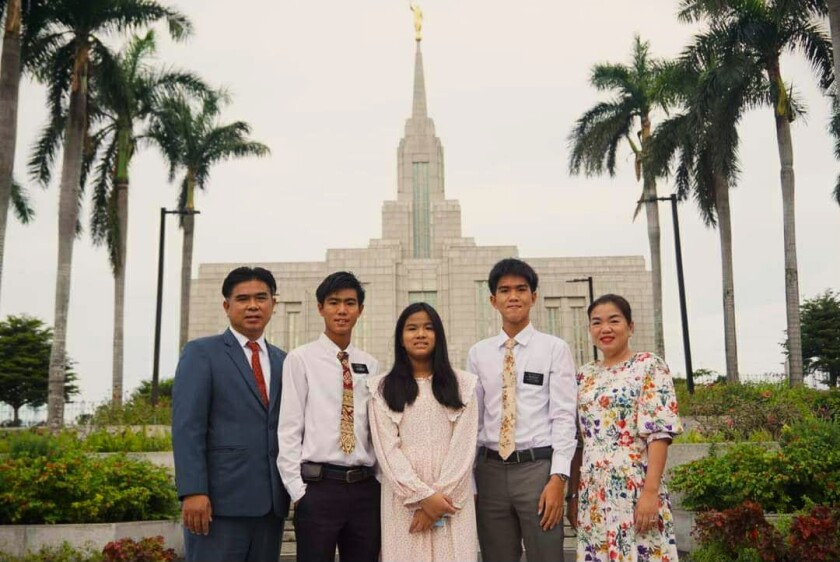 Arana Thongmee and his family in front of the temple in Thailand