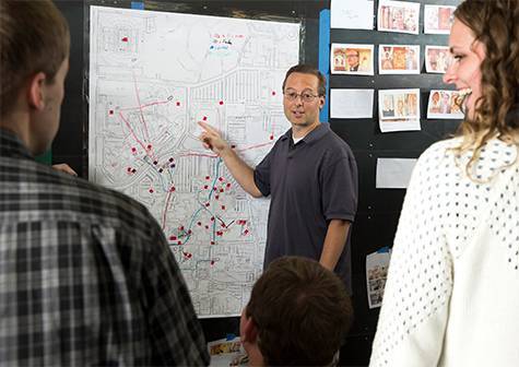 Information technology professor Derek Hansen addresses students in the Laycock Center.