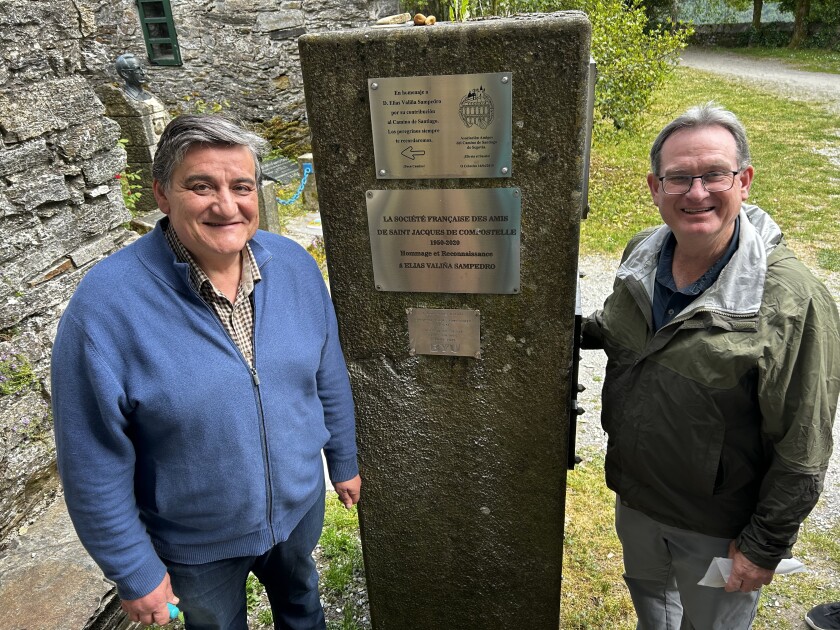 Jose Valiña and Professor Douglas J. Weatherford in front of the plaque that honors Father Elías Valiña.