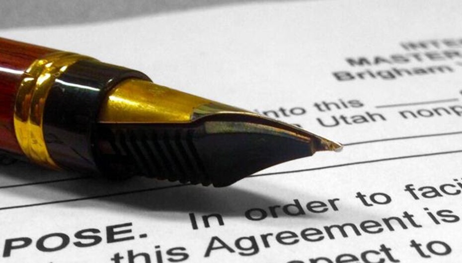 Pen on top of a blank internship agreement (contract)