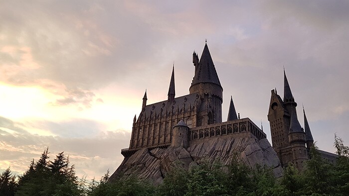 the Harry Potter castle sits on top of a rocky hillside