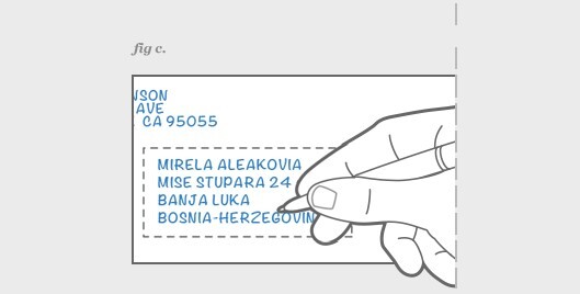 image of a hand writing in the address on an envelope