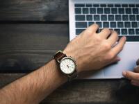 A young man looks at his wristwatch