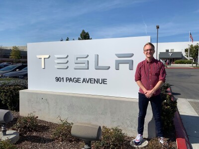 Tyler Lutz stands in front of one of Tesla's factories on 901 Page Avenue in Fremont, California