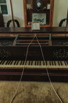 landscape shot of old upright piano inside Iolani Palace
