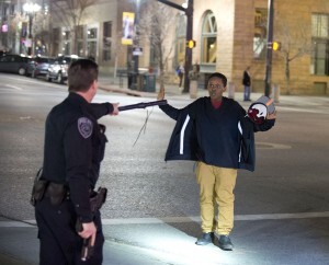 Police stop a boy as he walks away from a crowd that formed after an officer-involved shooting at 200 South Rio Grande Street in Salt Lake City, Saturday, Feb. 27, 2016. Unrest broke out in a Salt Lake City neighborhood on Saturday night after what appears to be a shooting involving a police officer, the Salt Lake Tribune reported. (Lennie Mahler/The Salt Lake Tribune via AP)