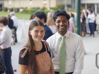 A couple smiling at the camera.