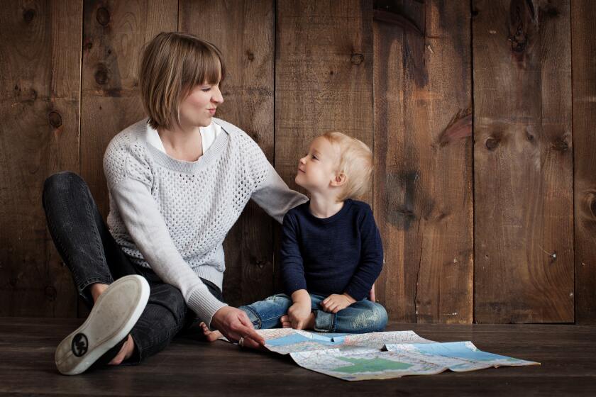 mother and son sitting on the floor together
