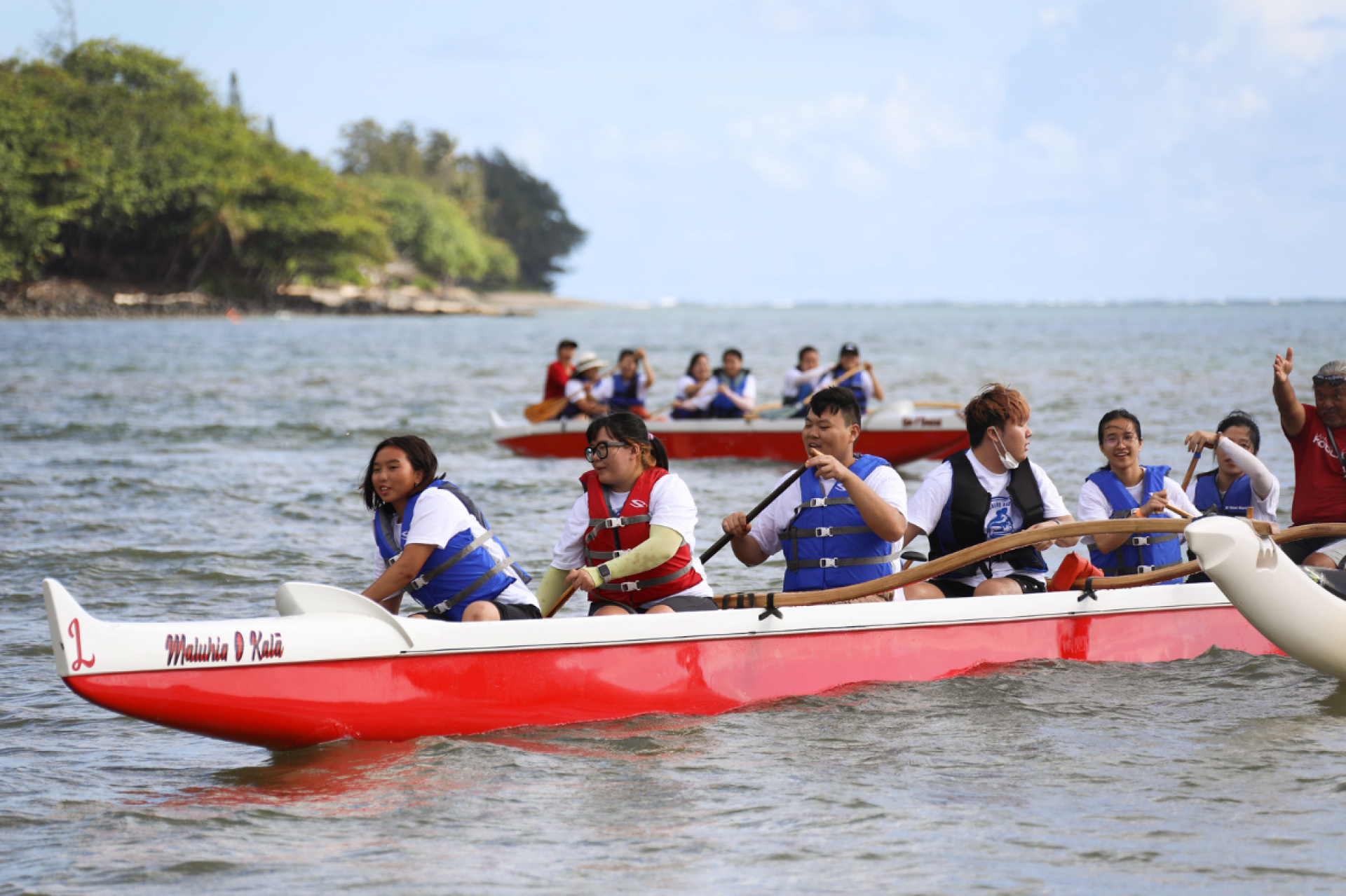 BYUH students participating in a canoe race at Kahana Bay.