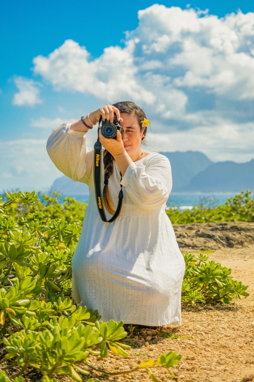 A photo of Vioanna Obley with her camera.