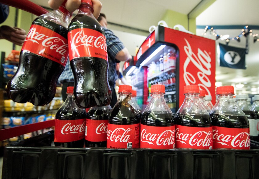 Dining Services employees stock Coca Cola bottles on campus