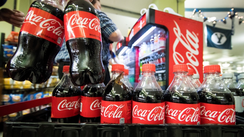 Dining Services employees stock Coca Cola bottles on campus