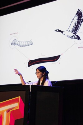 A student presenting her work at a conference.