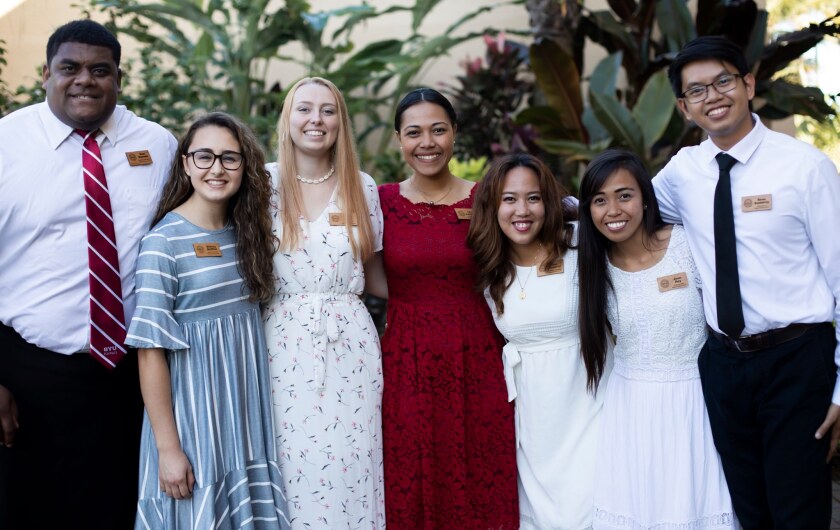 Seven members of the Student Advisory Council wearing formal clothes pose for a picture