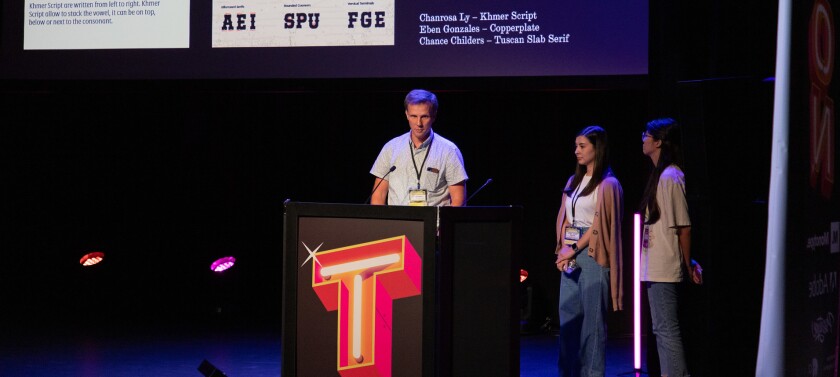 Students and a professor presenting at a conference