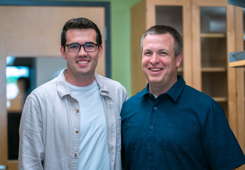 Two men smiling in a lab