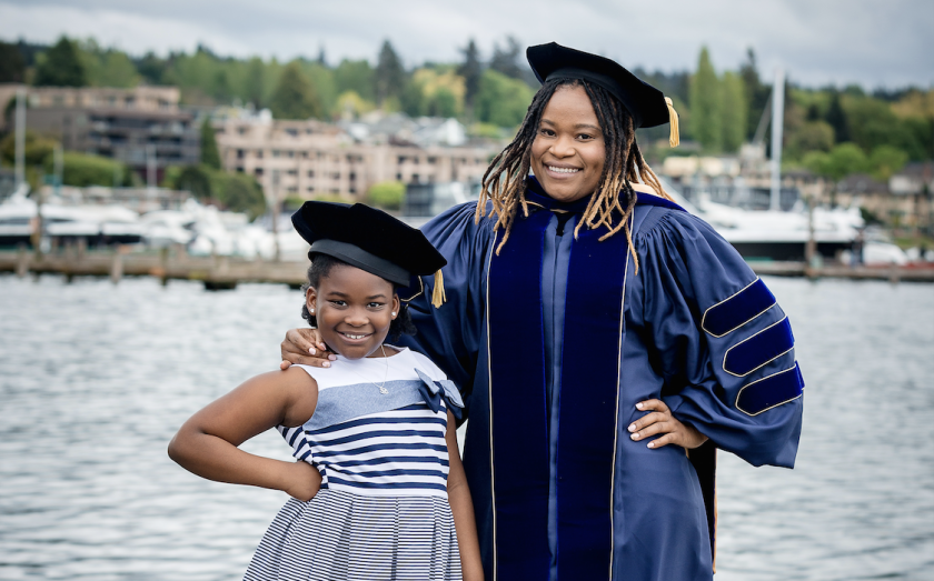 Dr. Allard-Blaisdell standing with her daughter in an outdoor setting.