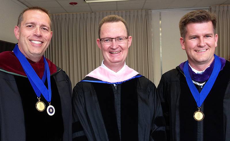 Left to right, outgoing director, Ed Adams; Dean Stephen Jones; incoming director, Ed Carter.