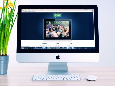 A computer with a group of people as wallpaper