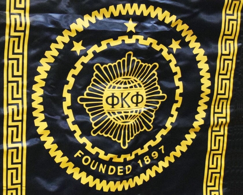 Phi Kappa Phi banner on a podium