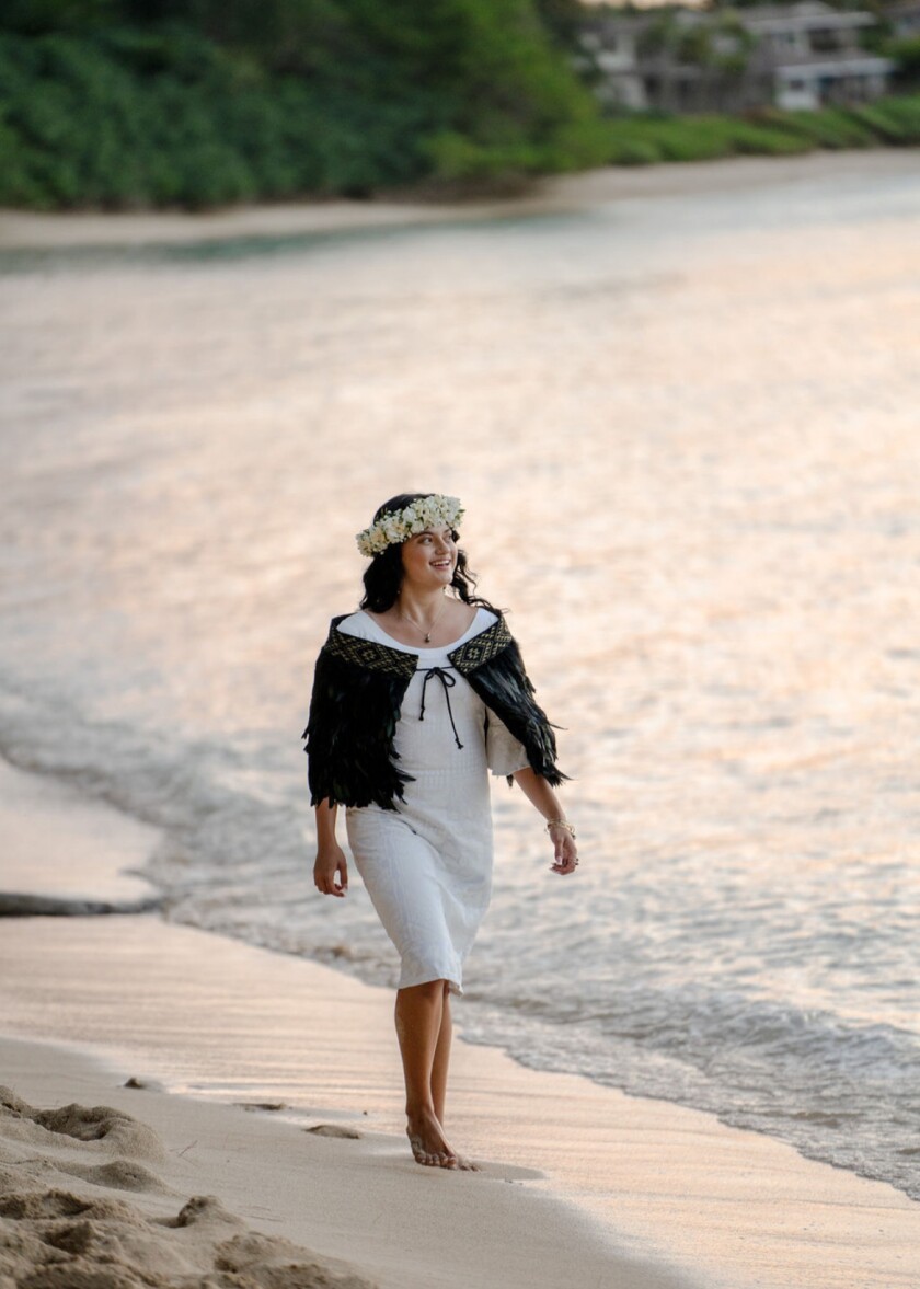 Arania Campbell walking along the beach.