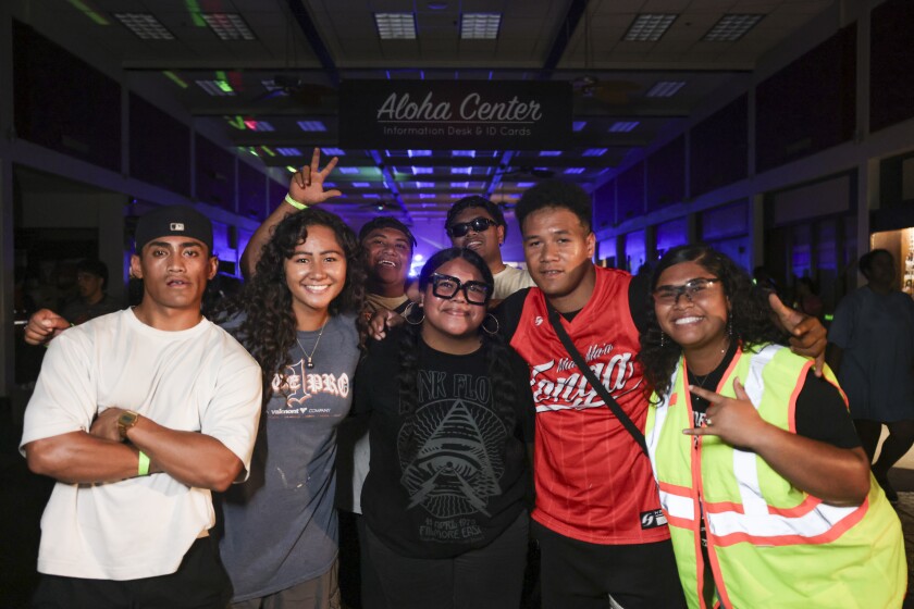 Students during a party event in the Aloha Center, posing for a photo