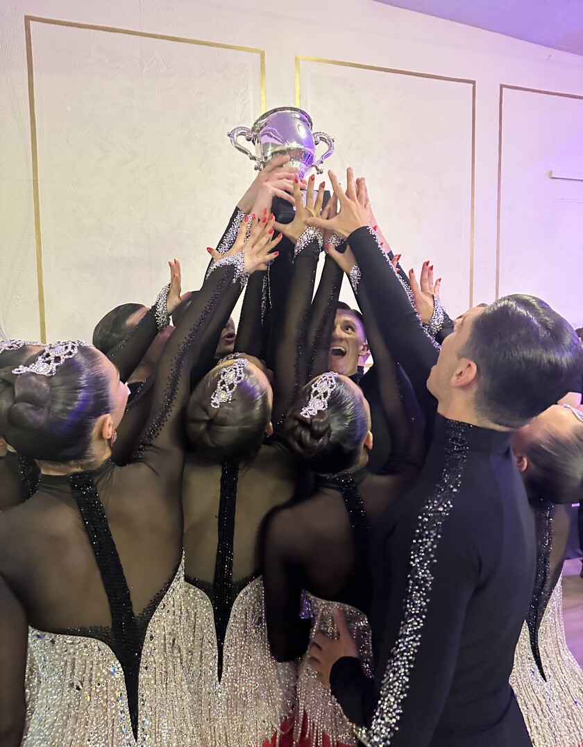 Students hold up a trophy and celebrate their win at Blackpool.