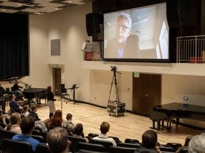 Robert McDonald on the big screen, answering student questions.