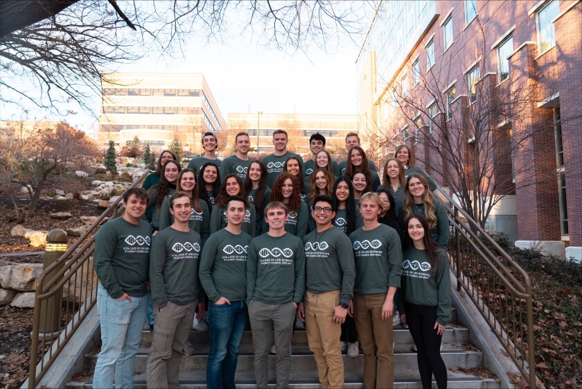 A group of student stands on a staircase.