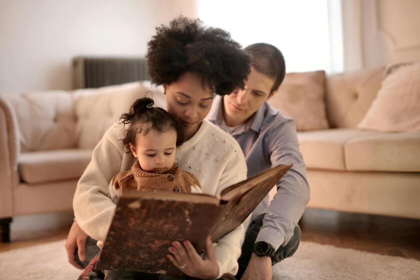 Parents reading to small child